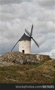 Old windmill in front of dense clouds in Andalucia