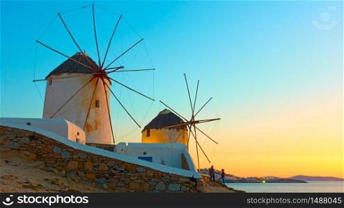 Old windmillls in Mykonos island at sunset, Cyclades, Greece. Greek landscape with space for your own text