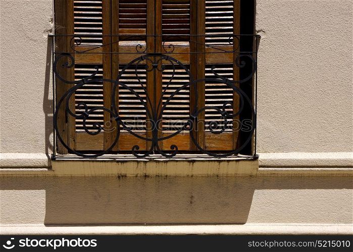 old window grate and shadow in the centre of colonia del sacramento uruguay