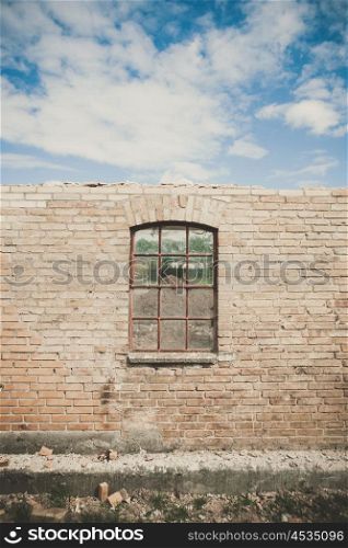 Old window on a wall in a damaged building