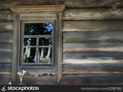 Old window on a wooden farm house wall