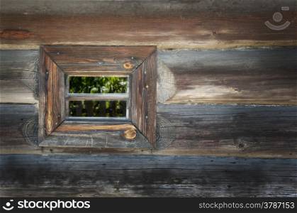 Old window on a wooden farm house wall