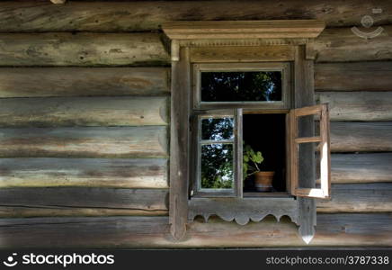 Old window on a wooden farm house wall