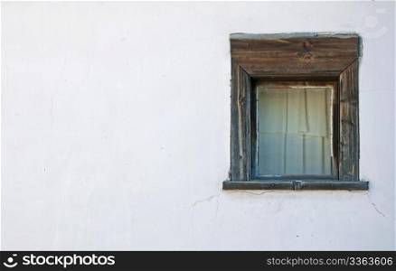 Old window on the white wall. Horisontal picture