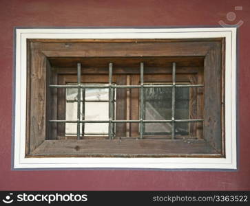 Old window with grid. Violet wall