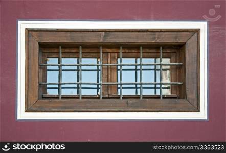 Old window with grid. Violet wall