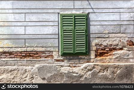 Old window with wooden shutters on wall and copy space