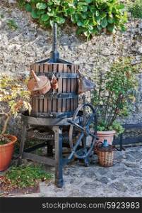 Old wine press in the yard of the rural French house