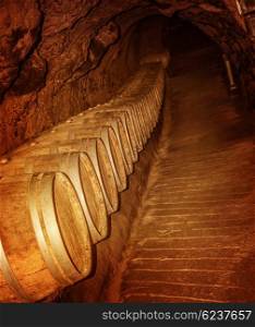 Old winery cave, wooden barrel with luxury wine in the basement, tasty alcoholic grape beverage, traditional lebanese wine production&#xA;