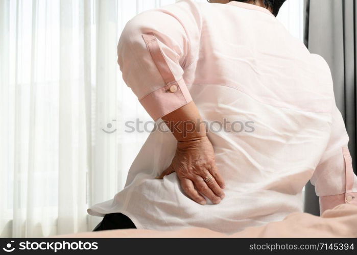 Old woman back pain at home, health problem concept