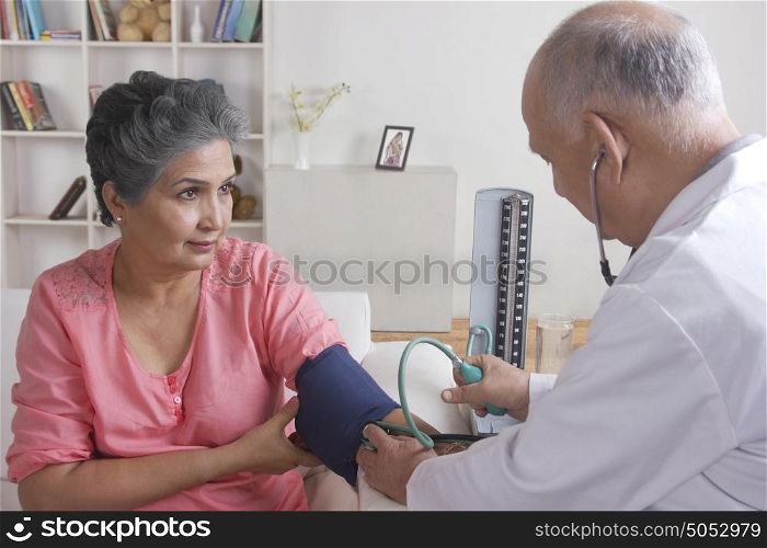Old woman getting her blood pressure checked