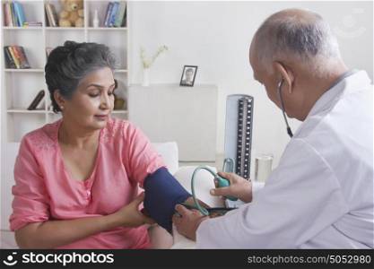 Old woman getting her blood pressure checked