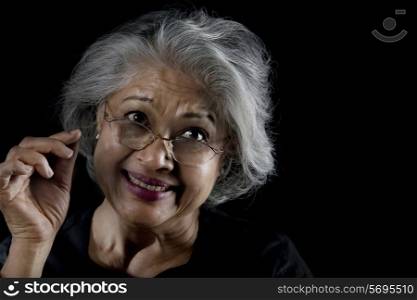 Old woman with glasses smiling