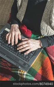 Old women using old laptop