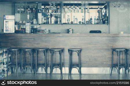 Old Wood alcoholic vntage bar cafe interior with chairs and bar counter.