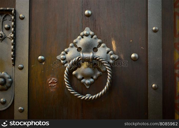 old wood door metal knocker close detail