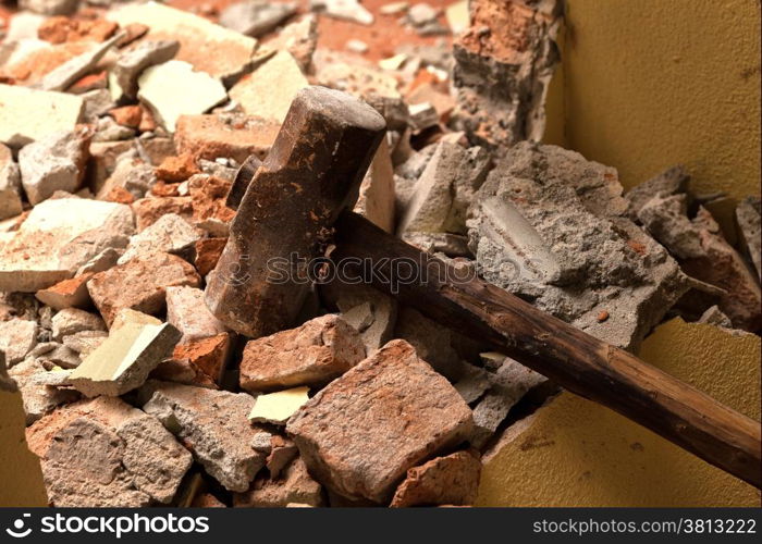Old wood hammer on broken brick wall