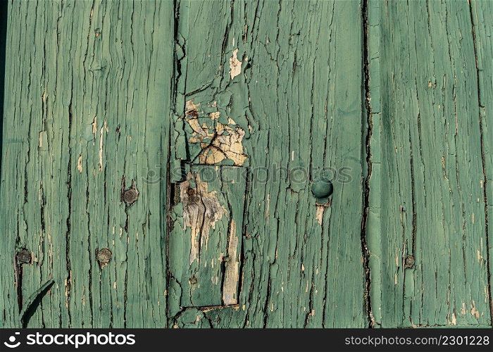 Old wood texture distressed grunge background, scratched green paint on planks of wood wall