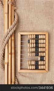 old wooden abacus on the background of bagging