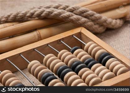 old wooden abacus on the background of bagging