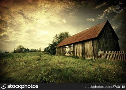 Old wooden bar with red roof over the dramatic sunset. Zalew Zegrzynski, Poland