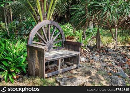 Old wooden bench in a tropical garden