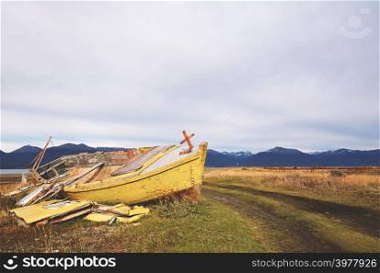 Old wooden boat abandoned ashore.