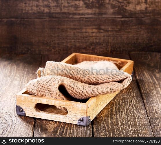 old wooden box with sack on wooden table