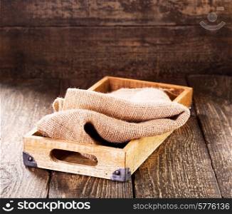 old wooden box with sack on wooden table