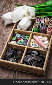 old wooden box with thread and buttons for needlework in vintage style
