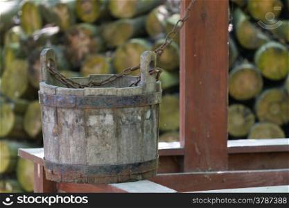 Old wooden bucket near a well