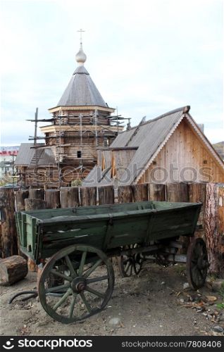 Old wooden cart near log wall in monastery, Murmansk, Russia