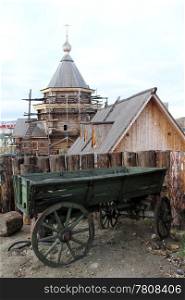 Old wooden cart near log wall in monastery, Murmansk, Russia