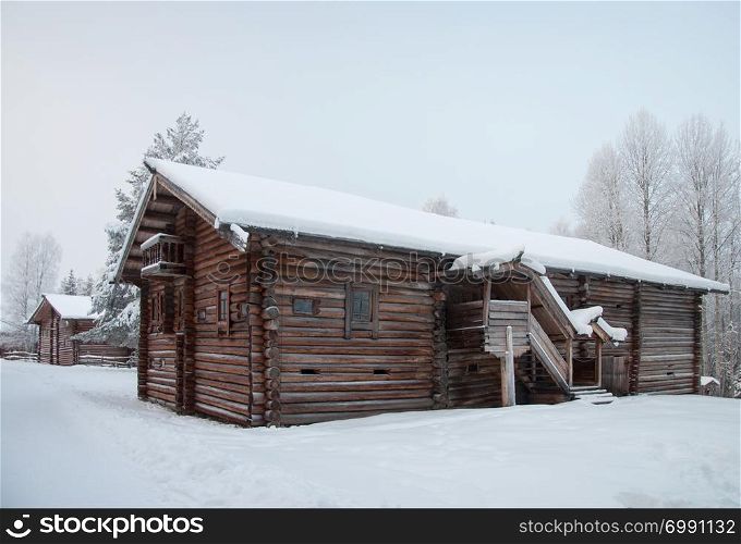 Old wooden country house in the northern open air museum Malye Korely near Arkhanglesk, Primorsk Region, Russia. Winter time.