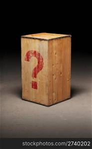 Old wooden crate with a photoshopped question mark on dirty concrete floor.