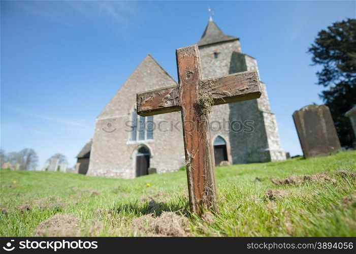 old wooden cross in a church graveyard