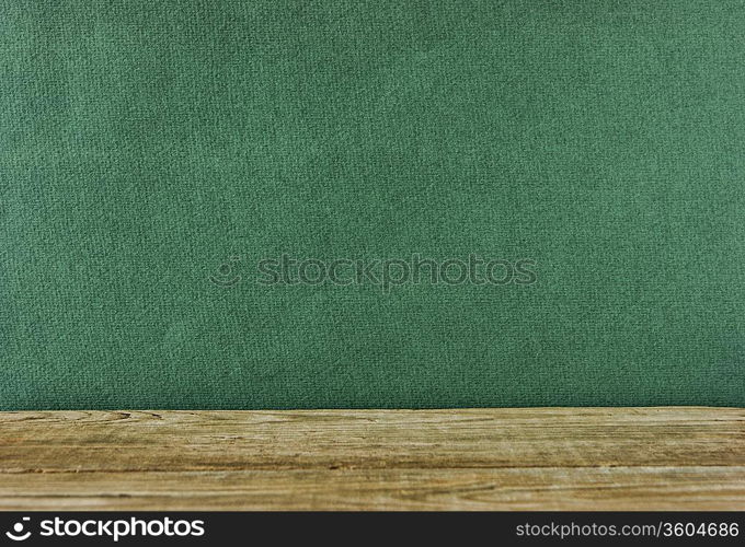 Old wooden deck table with green grunge background