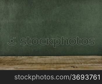 Old wooden deck table with green grunge background