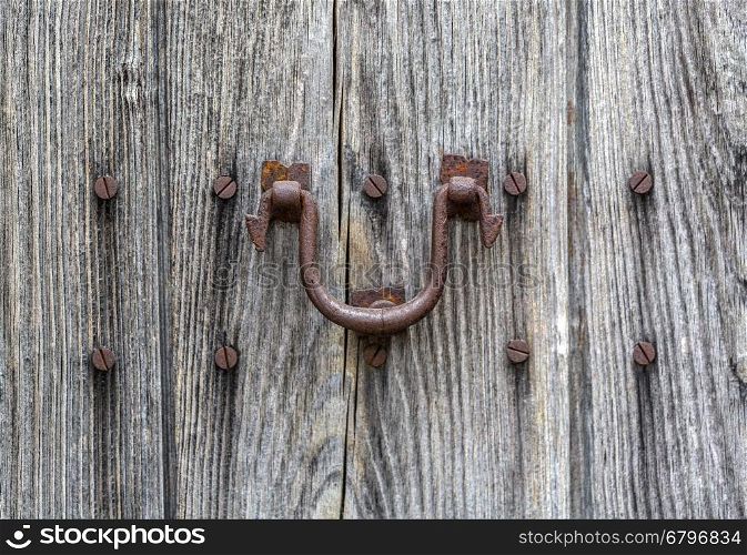 old wooden door and rusty iron knocker