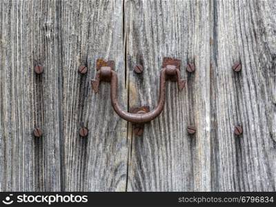 old wooden door and rusty iron knocker