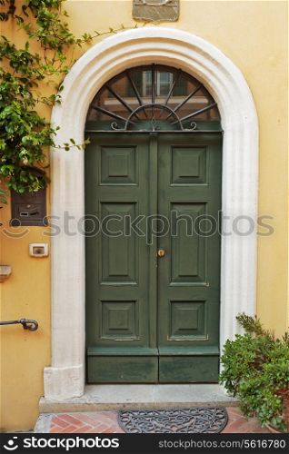 Old wooden door in a stone house Italian