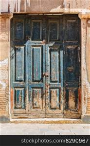 Old wooden door in a stone house Italian