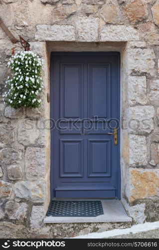 Old wooden door in the entrance stone French house