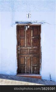 old wooden door with blue painted wall