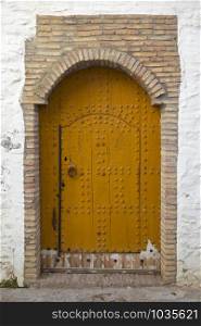 Old wooden door with decoration in the medina of Asilah, Morocco