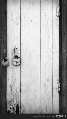 Old wooden door with hanging lock