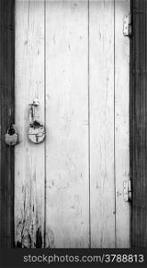 Old wooden door with hanging lock