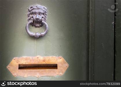 Old wooden door with knocker and letter box