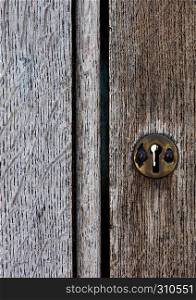 Old wooden door with metal lock close up texture background