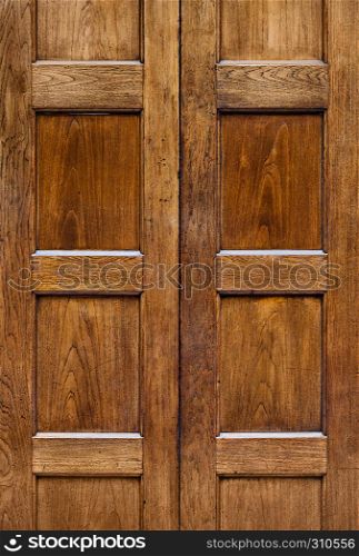 Old wooden door with square plates texture background